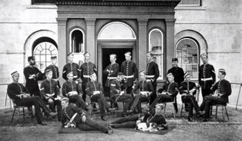 A group of men in uniform posing in front of the Royal Military College.