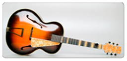 A sunburst-finished guitar is shown on a white background at the Canadian War Museum in Ottawa.