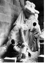 A group of men working on a sculpture.