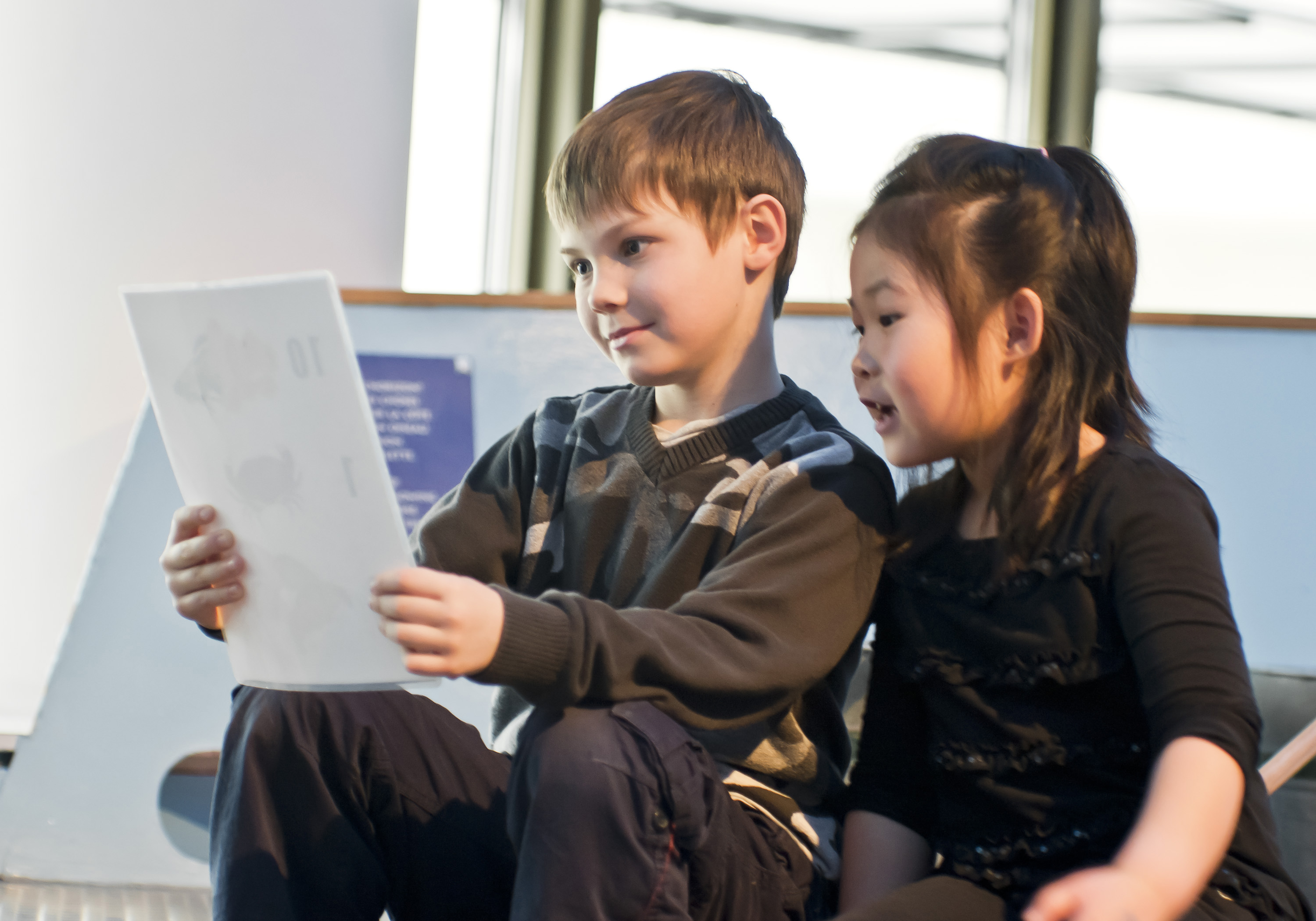 A boy and girl looking at a piece of paper at the Canadian War Museum in Ottawa.