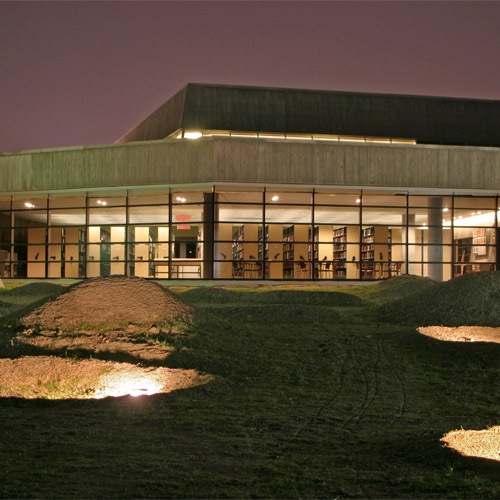 The Canadian War Museum, located in Ottawa, is a large building that is beautifully lit up at night.