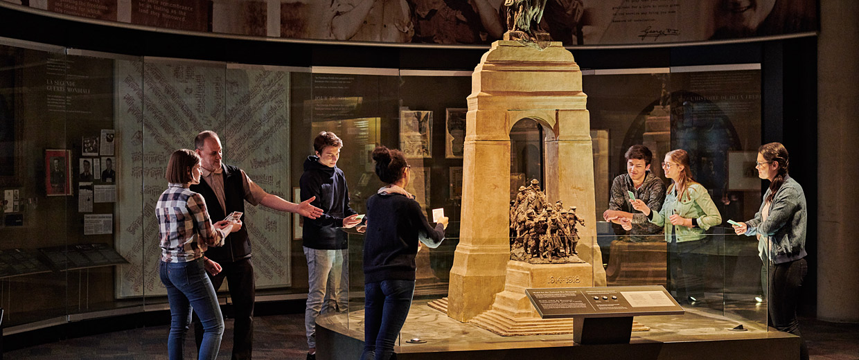 Visitors at the Canadian War Museum in Ottawa observing a monument.