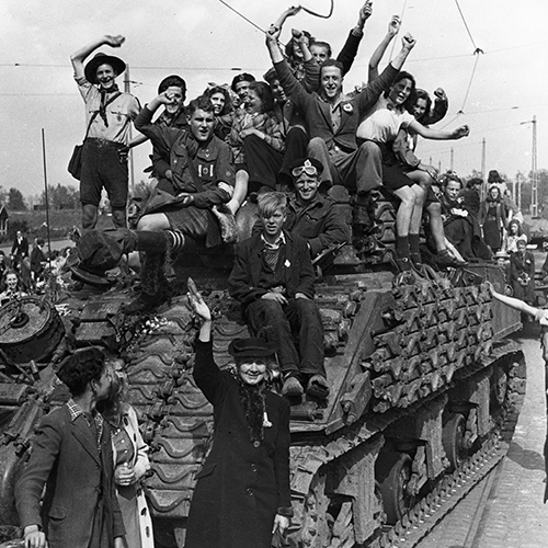 A group of people on the top of a tank at the Canadian War Museum in Ottawa.