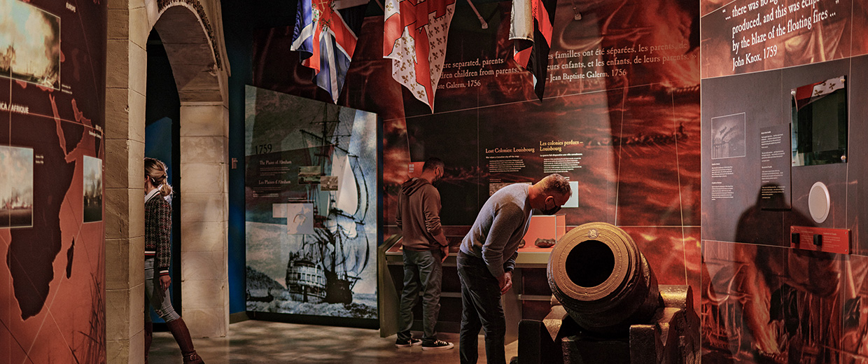 A group of people in Ottawa looking at a display of flags in the Canadian War Museum.