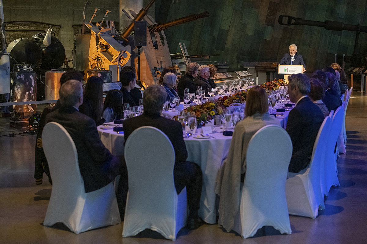 A group of people sitting at a table in the Canadian War Museum in Ottawa.