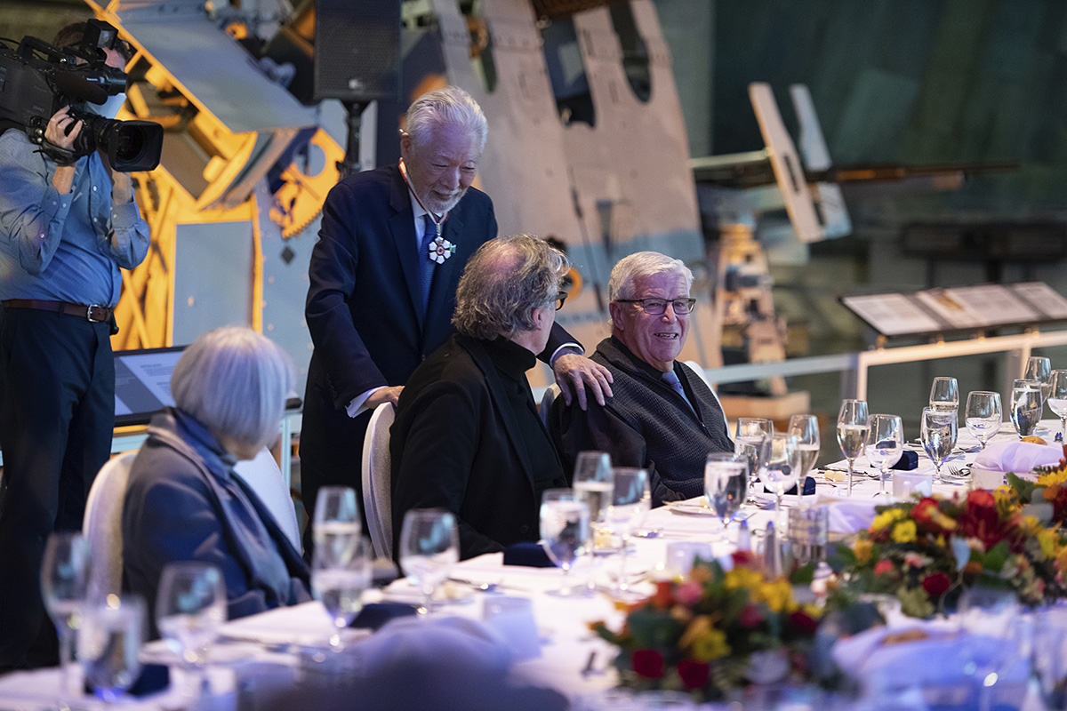 A group of people sitting at a table in the Canadian War Museum, Ottawa.