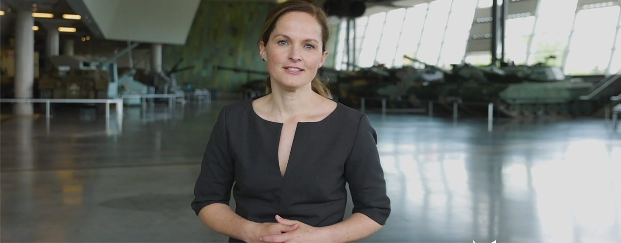 A woman standing in front of the Canadian War Museum, in Ottawa.