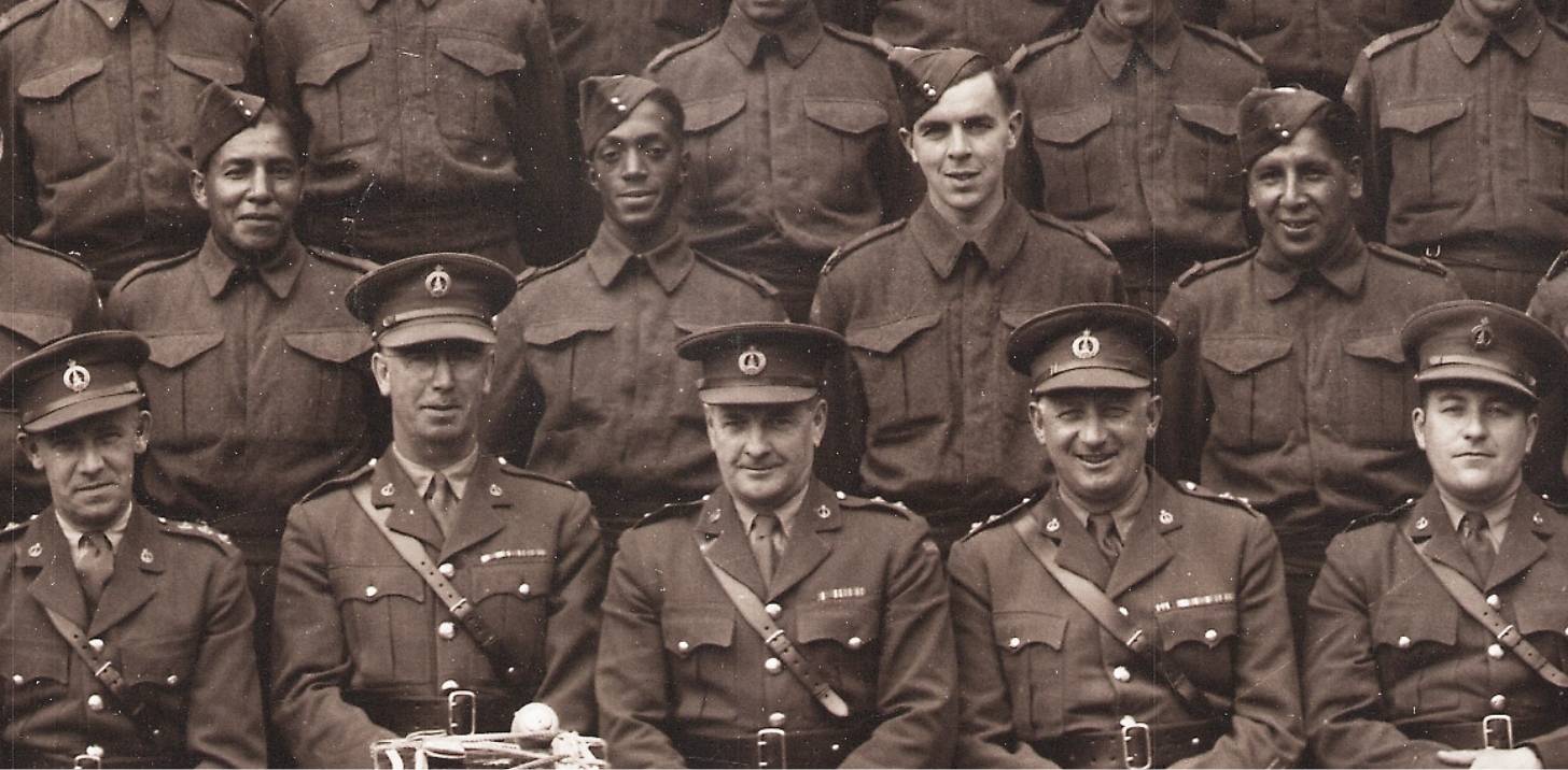 A group of men in uniform from the Canadian War Museum posing for a photo.