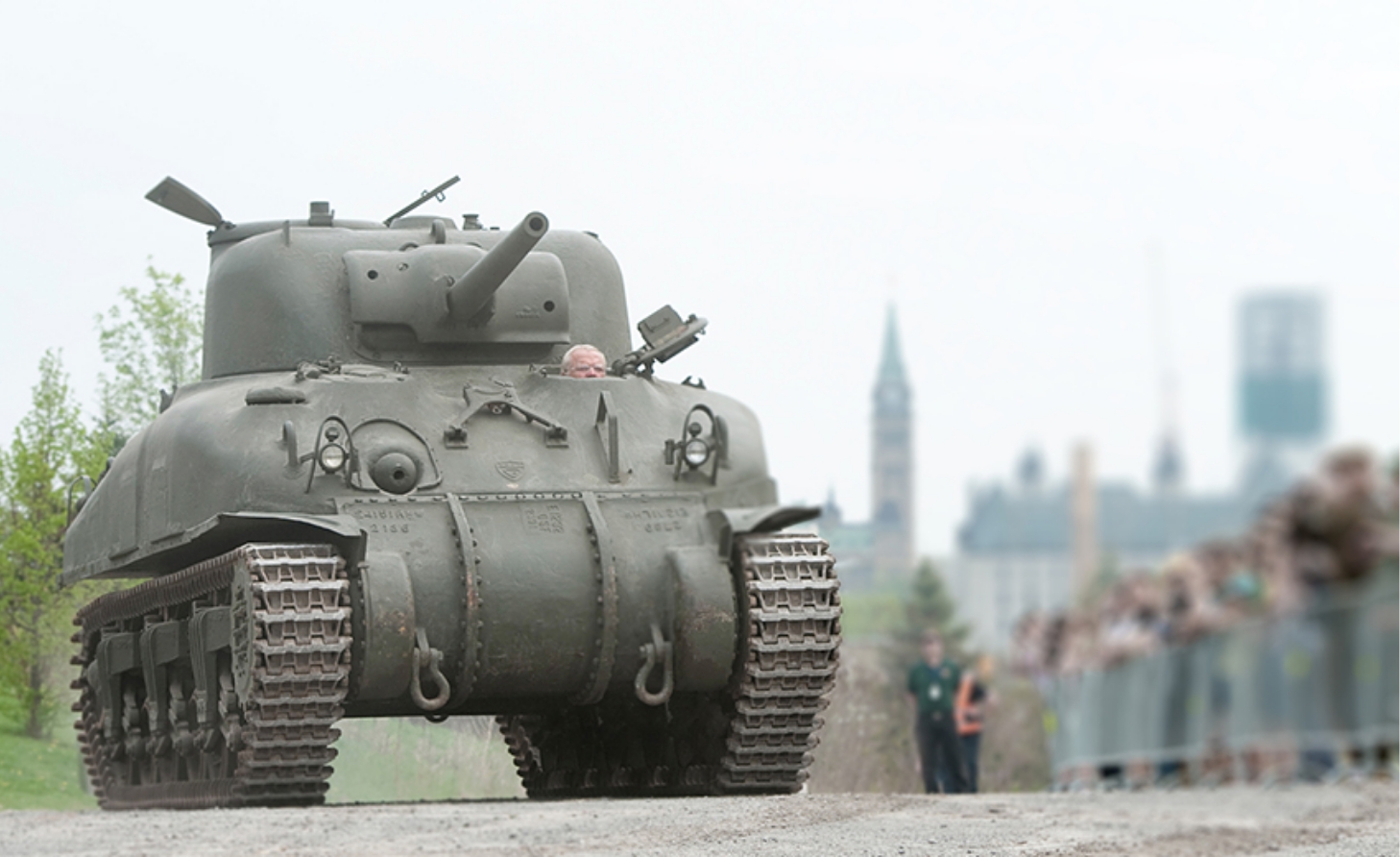 A tank driving down a dirt road near the Canadian War Museum in Ottawa.