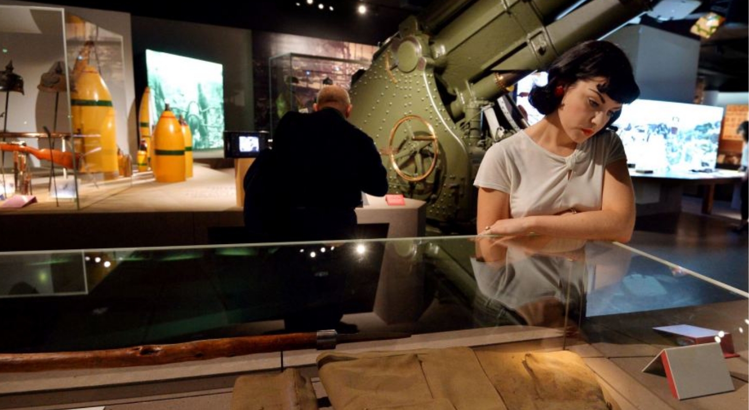 At the Canadian War Museum in Ottawa, a woman gazes at a display of a gun.