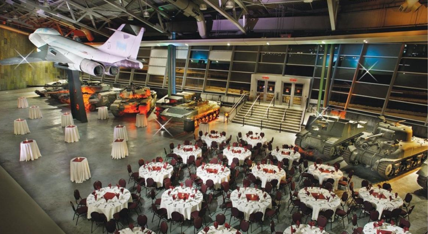 In Ottawa's Canadian War Museum, visitors can explore a room filled with tables and chairs, as well as a captivating display of military vehicles.