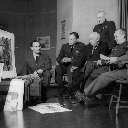 A group of men in uniform sitting around a table at the Canadian War Museum in Ottawa.