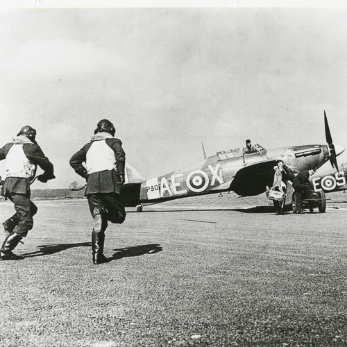 Two aviators running toward a plane