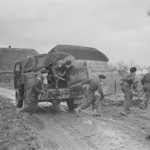 Soldiers pulling a truck on a dirt road in Ottawa, near the Canadian War Museum.