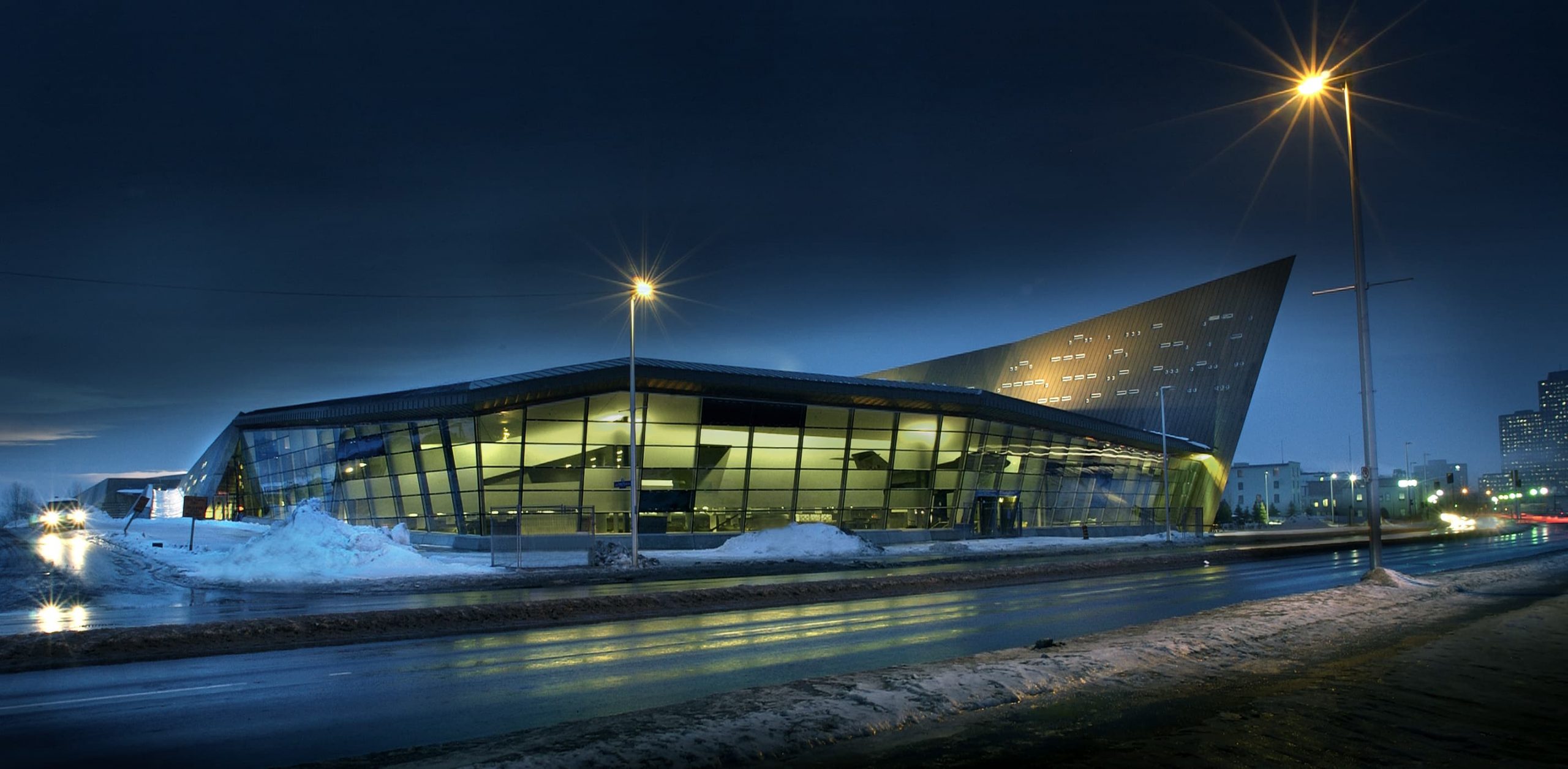 The Canadian War Museum, located in Ottawa, is a modern building that is beautifully lit up at night.