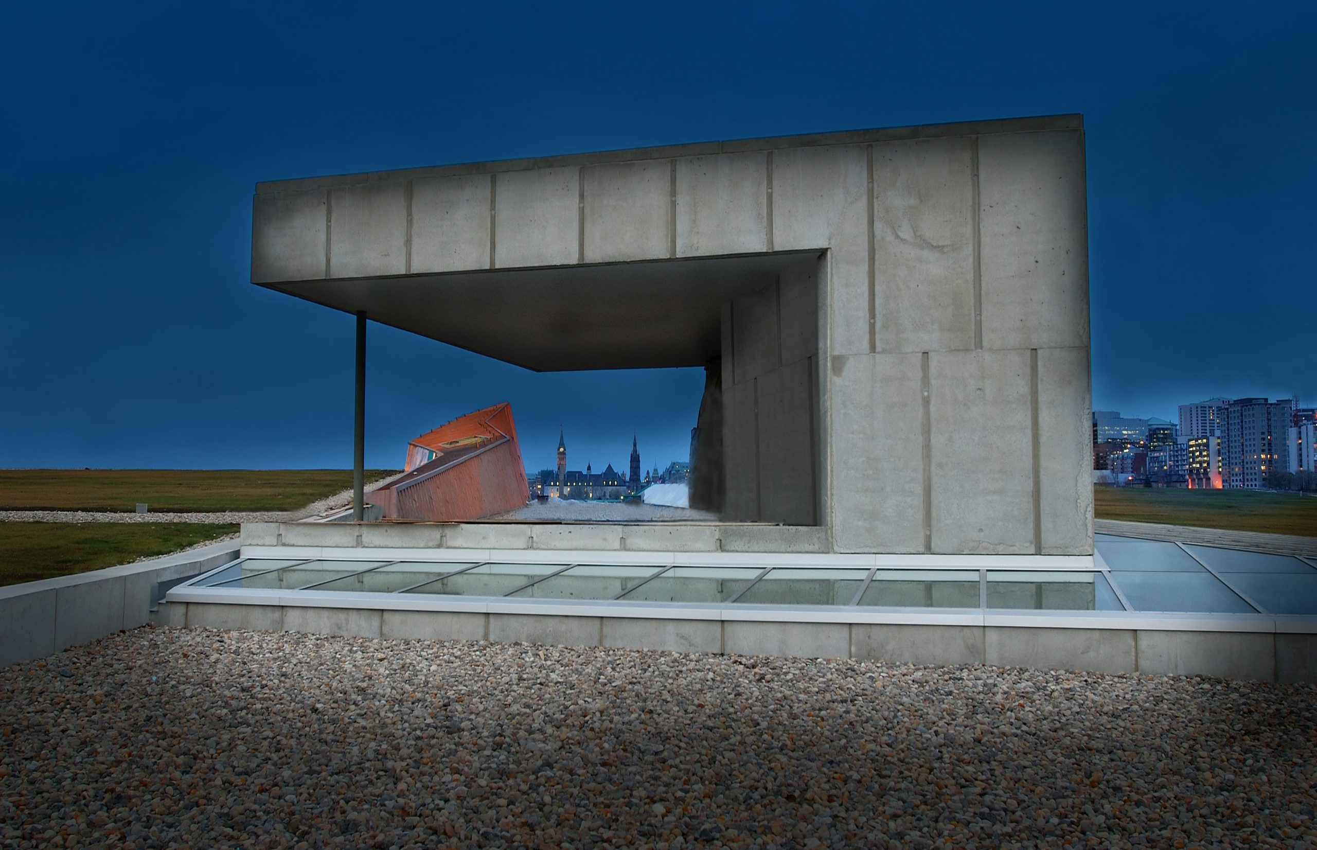 The Canadian War Museum in Ottawa is a concrete building with a stunning view of the city at night.