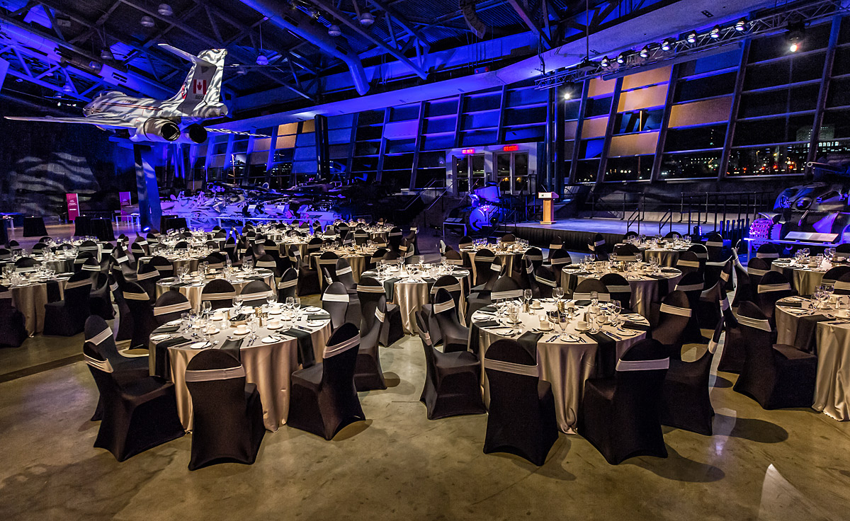 The LeBreton Gallery with tables and chairs set up for a dinner, located at the Canadian War Museum in Ottawa.