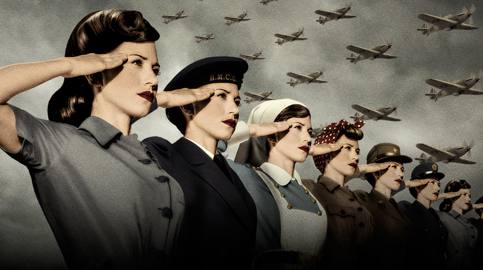 A group of women saluting in front of planes.