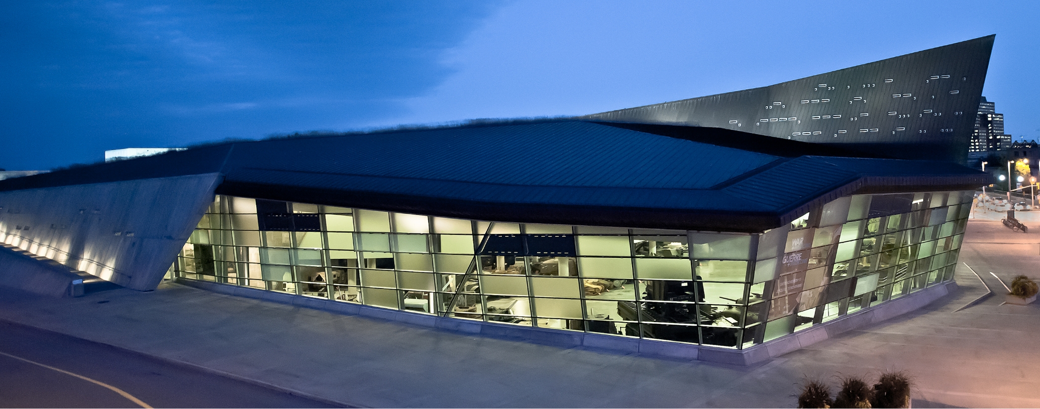 The Canadian War Museum in Ottawa, with a large glass roof that sparkles brilliantly at night.