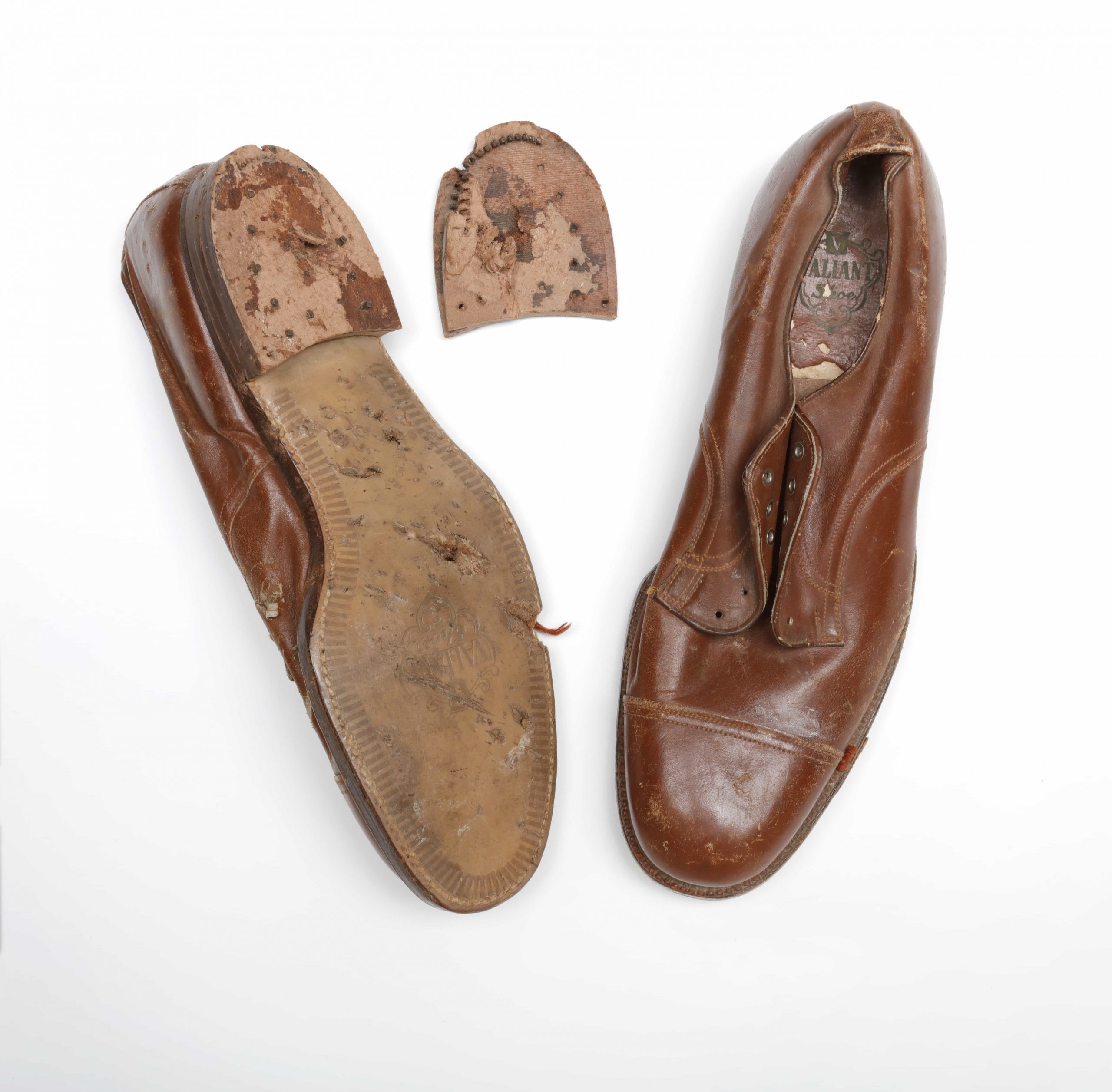 A pair of brown shoes with a hole in the sole found at the Canadian War Museum in Ottawa.