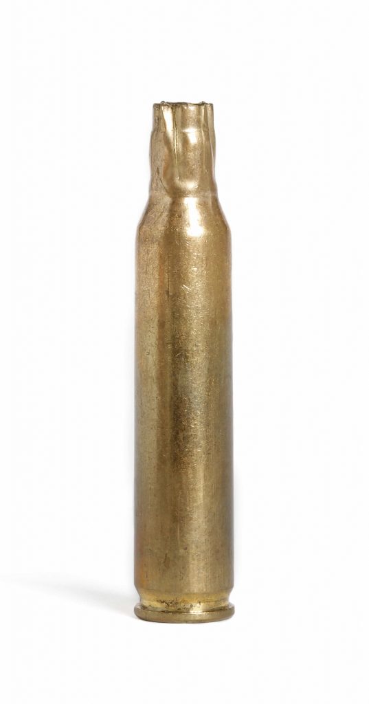 A brass bullet bottle on a white background at the Canadian War Museum in Ottawa.