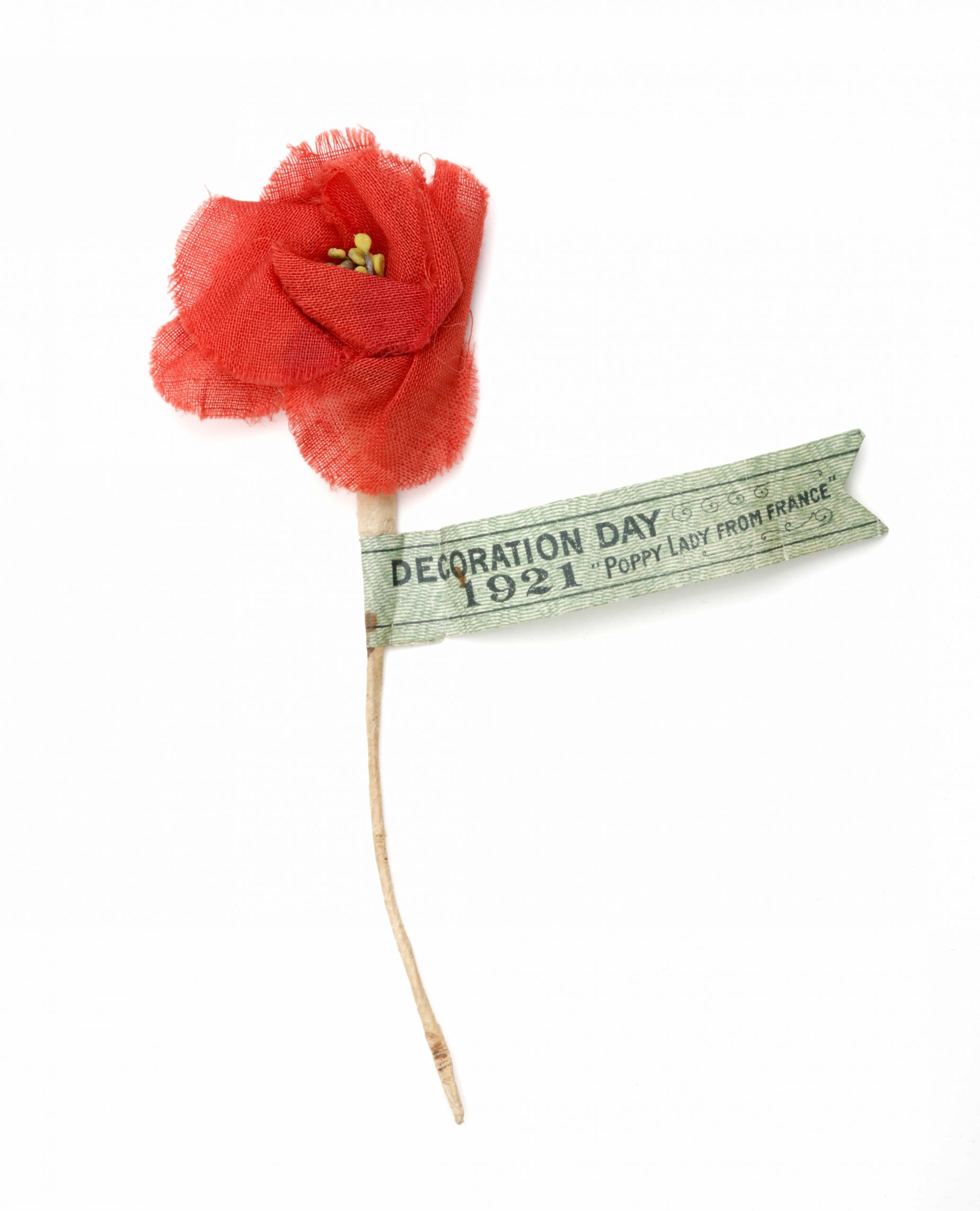 A red poppy with a label on it, displayed in the Canadian War Museum in Ottawa.