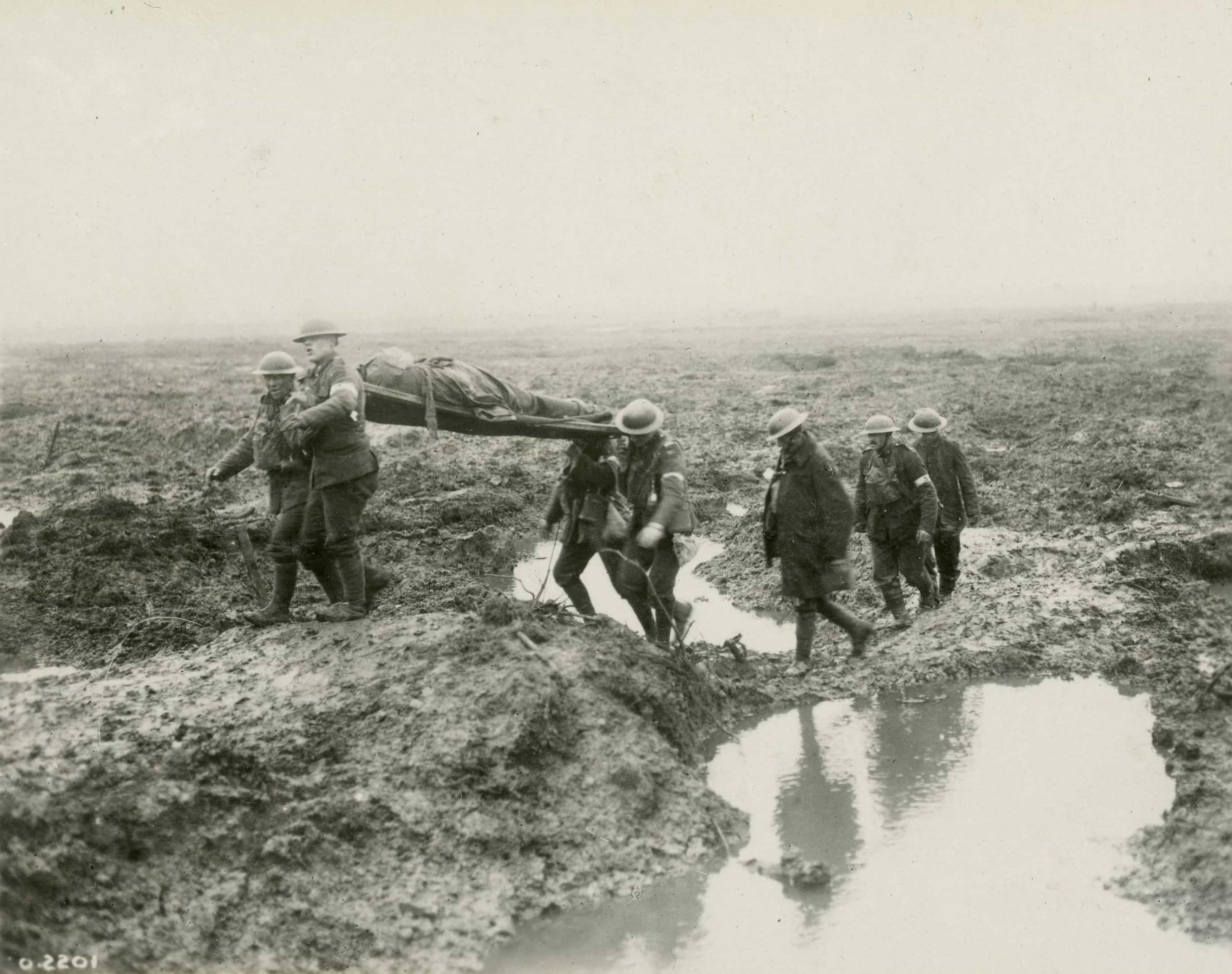 A group of men carrying a body through a muddy area near the Canadian War Museum in Ottawa.