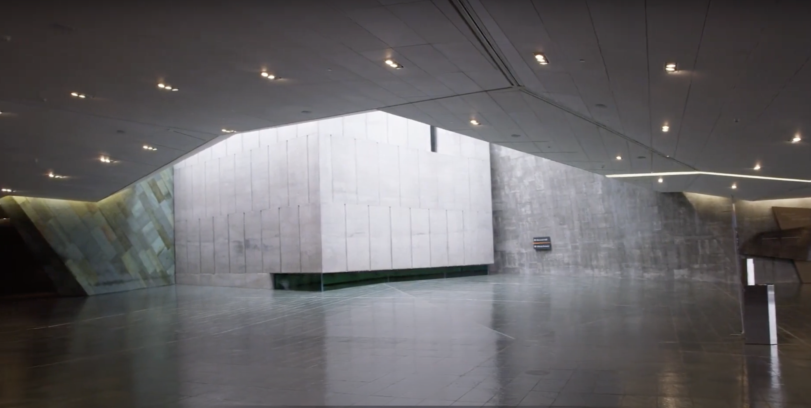 The interior of the Canadian War Museum, a modern building in Ottawa, with concrete walls.