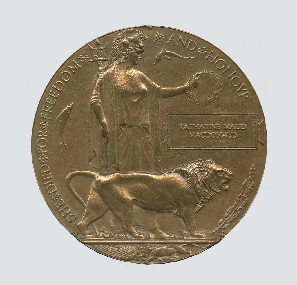 A bronze medal with a woman and a lion showcased at the Canadian War Museum in Ottawa.