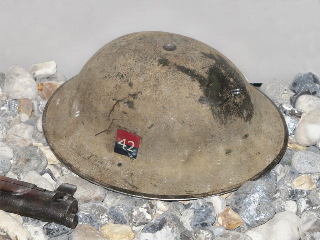 At the Canadian War Museum in Ottawa, a WWII helmet is sitting on a rock.