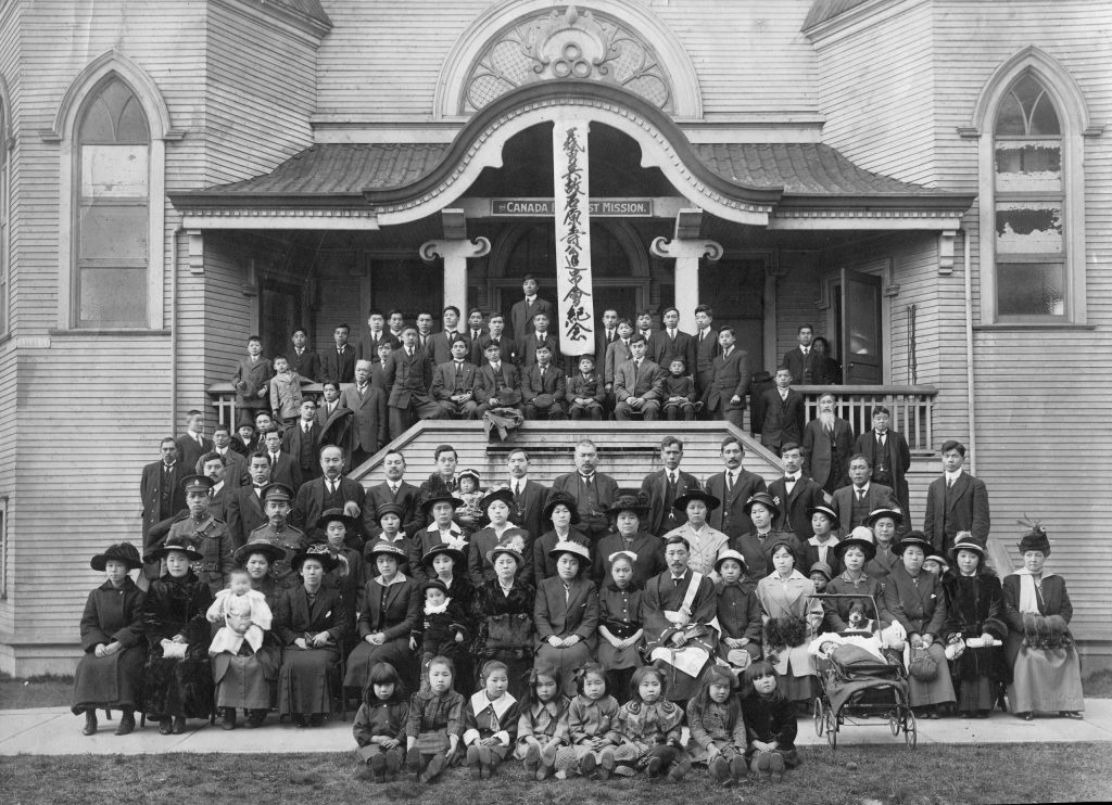 A group of people posing on the steps of the Canadian War Museum in Ottawa.