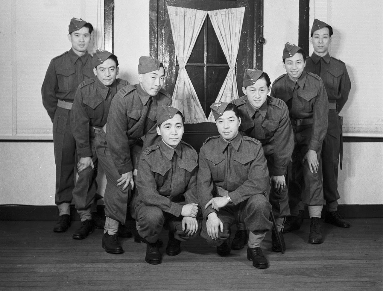 A group of men in uniform posing for a photo.