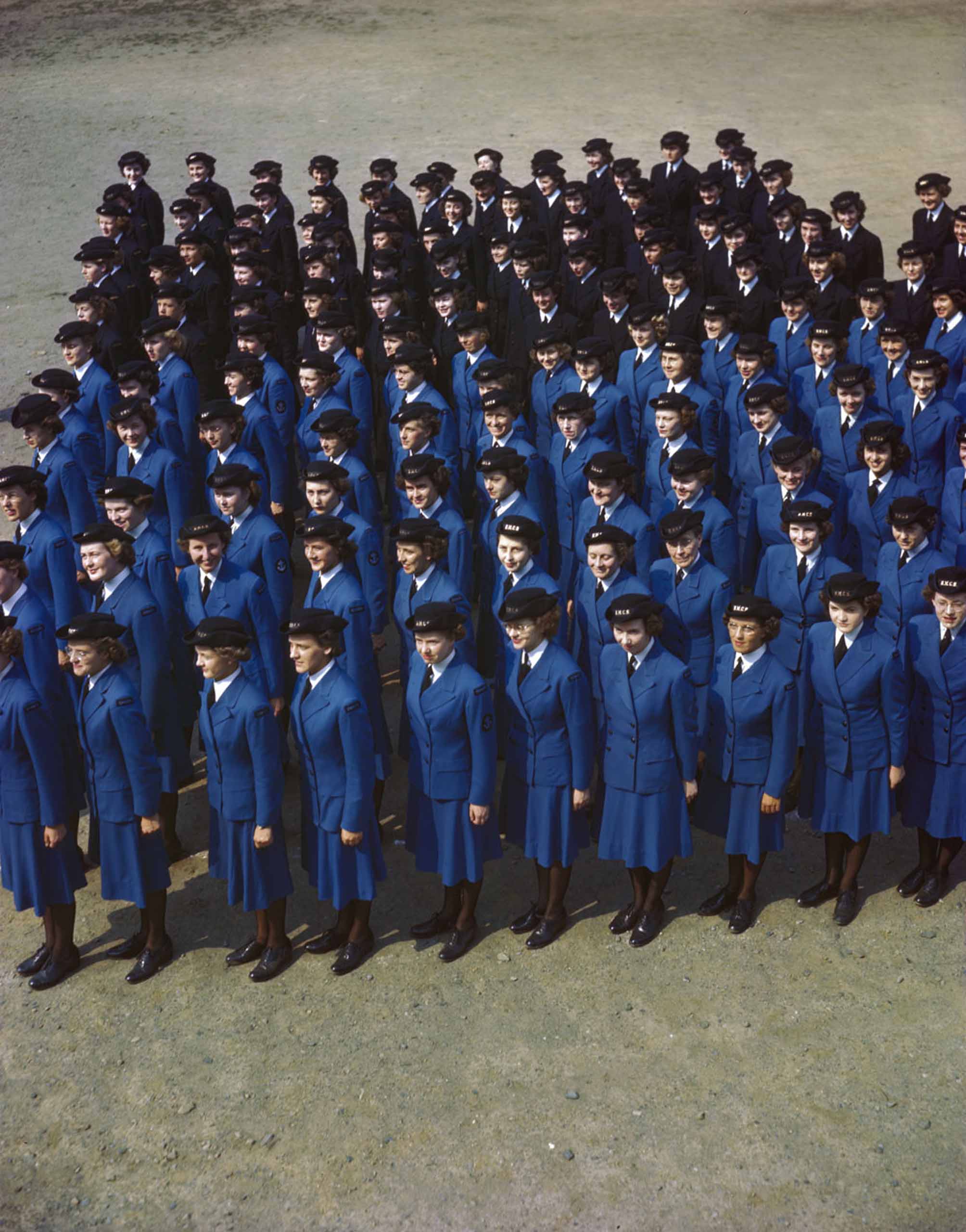 A group of women in blue uniforms standing in a line.